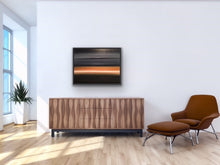 Load image into Gallery viewer, Studio Brambilla Aware Winning Toronto Artist: Home Decor: As you're dreaming, you see the light on the horizon surrounded by a bronze glow. The rest of the sky and water are black to dark grey and there is a cloud floating above... or is that an island in the sky? Relax. You are entering a peaceful place and looking forward to exploring the light. At 24"x30" this oil on canvas work is suitable for medium sized spaces finished smartly with a black floating frame.