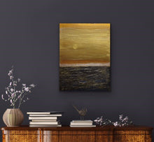Load image into Gallery viewer, Studio Brambilla Aware Winning Toronto Artist: Home Decor: This pretty much depicts life don't you think. The sky is a beautiful gold but the seas are quite rough. The good and bad. The Yin and Yang. A thought provoking composition. I wanted to feel the roughness of the water so I used Venetian Plaster on a wood panel to get the rough texture and the sky is painted with high end metallic gold paint. If you look closely you'll see the sun breaking through...so there is a happy ending!